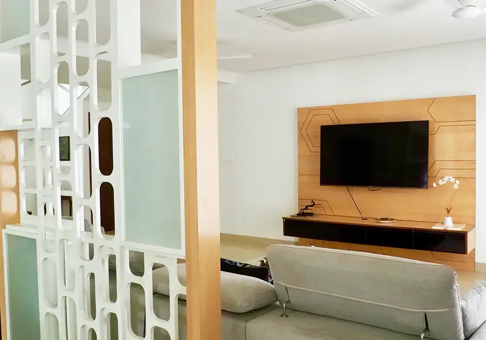 Living room TV unit seen through a geometric partition